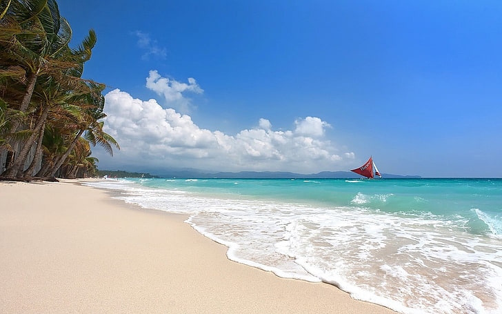 A view of Boracay Beach, sailboat in the background